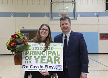  Dr. Cassie Eley of Piedmont Middle named Principal of the Year smiling with superintendent